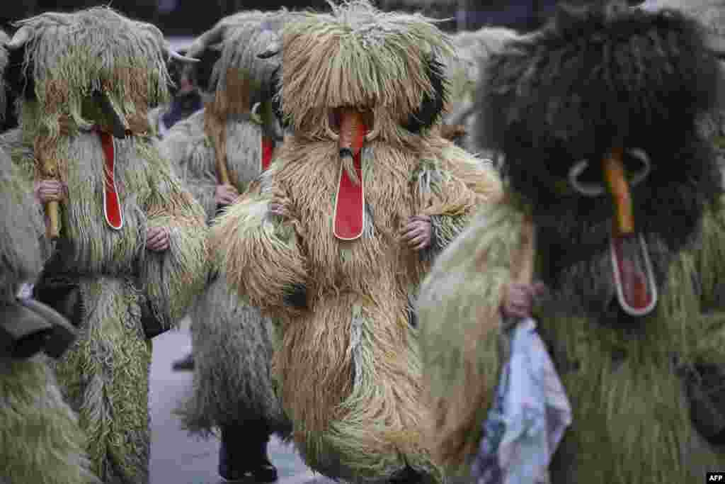 Dancers, known as Kukeri, wearing costumes perform during the International Festival of the Masquerade Games in Pernik, near Sofia, Bulgaria, Jan. 28, 2023.
