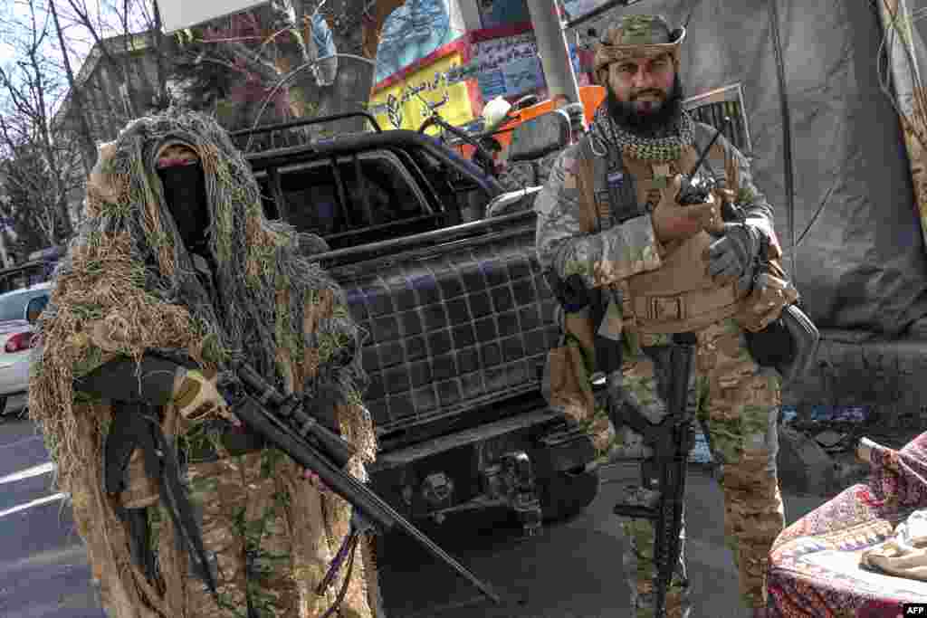 Taliban security personnel stand guard along a road in Kabul, Afghanistan. Hundreds of young women were prevented from entering Afghan university campuses, a day after the nation's Taliban rulers banned them from higher education.