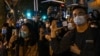 People gather on a street in Shanghai on November 27, 2022, where protests against China's zero-Covid policy took place the night before following a deadly fire in Urumqi, the capital of the Xinjiang region.