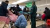A sickened patient is moved onto a gurney at the emergency department of the Langfang No. 4 People's Hospital in Bazhou city in northern China's Hebei province on, Dec. 22, 2022. 