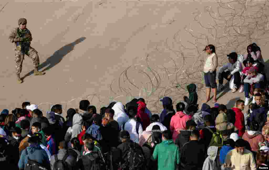 A member of the Texas National Guard monitors the banks of the Rio Bravo river, the border between the United States and Mexico, with the purpose of reinforcing border security and inhibiting the crossing of migrants into the United States, after the U.S. Supreme Court said Title 42 should stand as is for now, as seen from Ciudad Juarez, Mexico, Dec. 20, 2022.