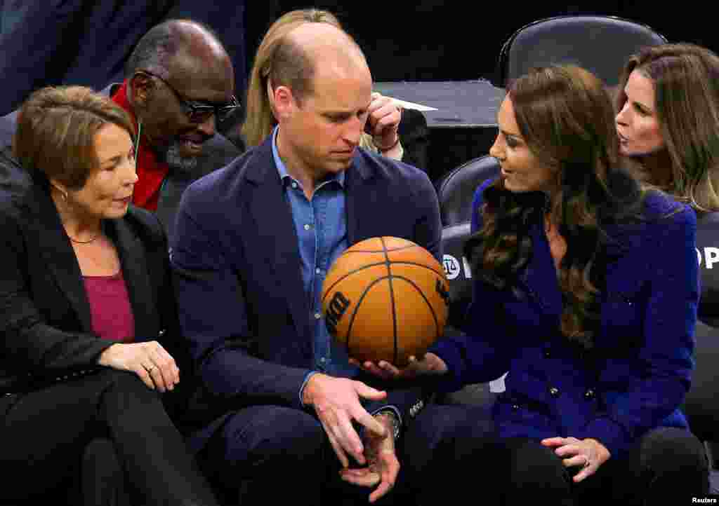 Massachusetts Governor-elect Maura Healey looks on as Britain's Catherine, Princess of Wales, handed a basketball to Prince William during the Wednesday night National Basketball Association game between the seventeen-time World Champion Boston Celtics and the Miami Heat at TD Garden in downtown Boston, Nov. 30, 2022.