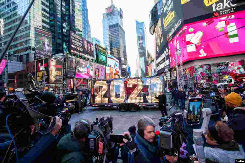 People take a look at the giant, seven-foot-tall numerals for "2023", as it arrives for the December 31 Times New Year's Eve celebrations, at Times Square in New York City.