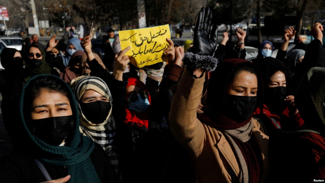 FILE - Afghan women chant slogans to protest the closure of universities to women by the Taliban, in Kabul, Dec. 22, 2022.