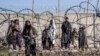 Taliban fighters check the site of an explosion, near the Interior Ministry, in Kabul on January 1, 2023. (Ebrahim Noroozi/AP)