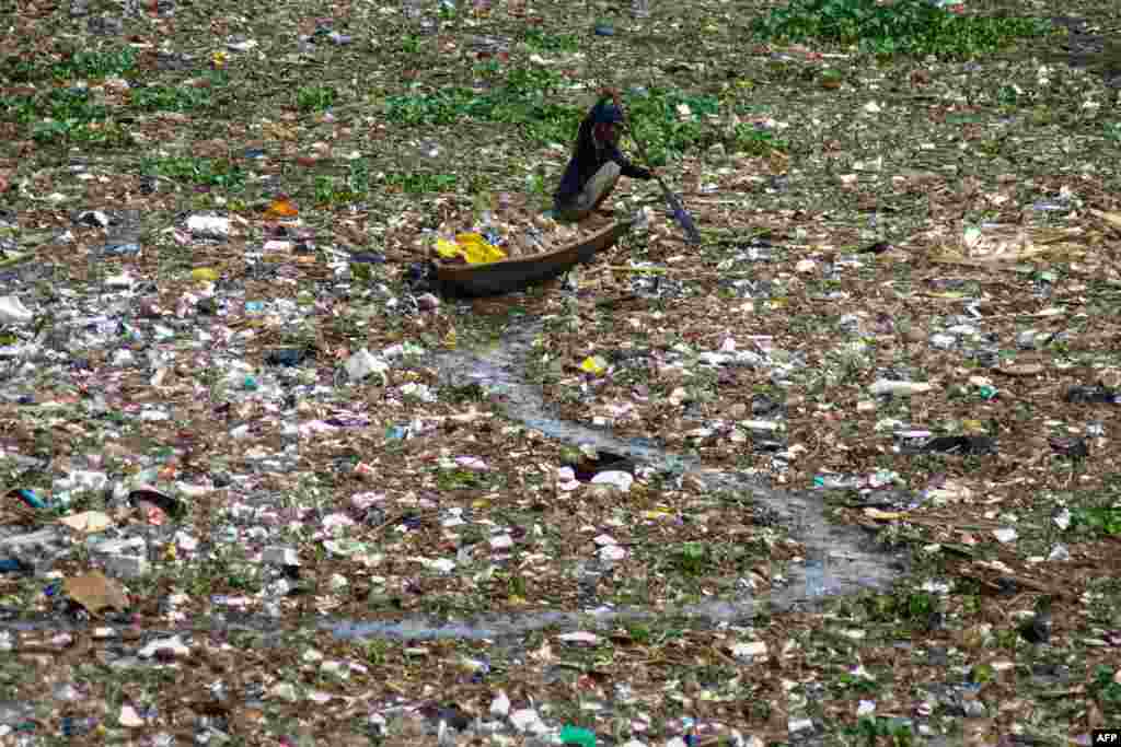A man collects plastic from the polluted Citarum river in West Bandung, Indonesia.