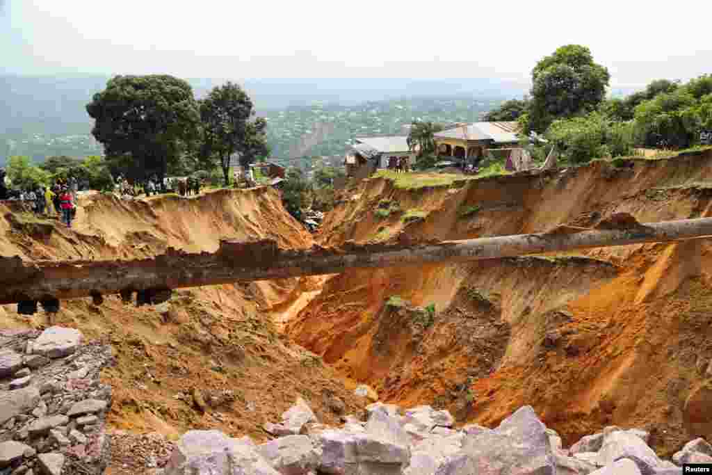 A view of a seriously damaged road after heavy rains caused floods and landslides, on the outskirts of Kinshasa, Democratic Republic of Congo.