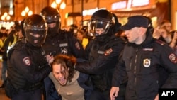 Police officers detain a man in Moscow on September 21, 2022, following calls to protest against a partial mobilization announced by President Vladimir Putin, after Russia's invasion of Ukraine earlier that year. (Alexander Nemenov/AFP)