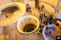 Technicians work at the Arak heavy water reactor's secondary circuit, as officials and media visit the site, near Arak on December 23, 2019. (Atomic Energy Organization of Iran.via AP)