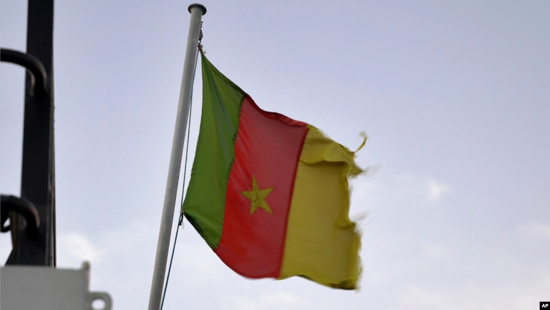 FILE - A Cameroonian flag flies on a ship at the port in Douala, Cameroon, Apr. 10, 2022.