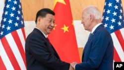 U.S. President Joe Biden, right, and Chinese President Xi Jinping shake hands before a meeting on the sidelines of the G20 summit meeting on November 14, 2022, in Bali, Indonesia. (Alex Brandon/AP)