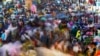 People move through a market in Mumbai, India, Nov. 12, 2022.
