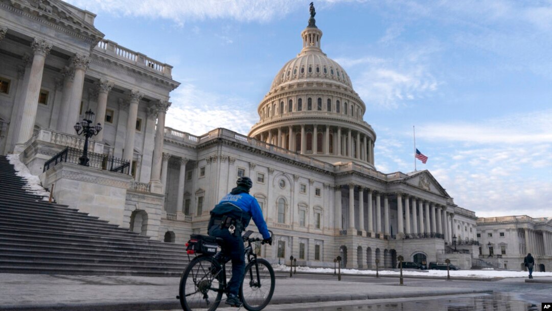 A US Capitol Police bicycle officer patrols the plaza, on the East Front of the US Capitol, Jan. 5, 2022, in Washington. 