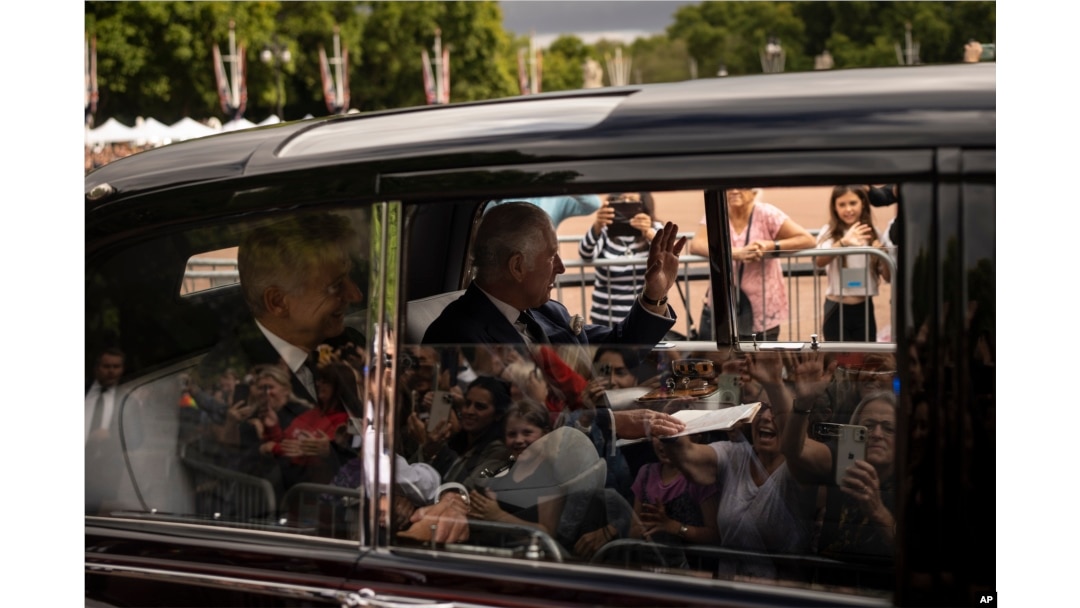 King Charles III greets supporters as he arrives at Buckingham Palace in London, Sept. 10, 2022.