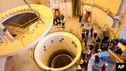 Technicians work at the Arak heavy water reactor's secondary circuit, as officials and media visit the site, near Arak on December 23, 2019. (Atomic Energy Organization of Iran.via AP)