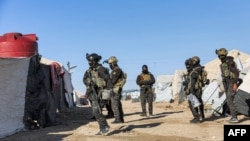An image obtained from the media office of the Kurdish People's Protection Units in Syria (YPG) March 29, 2021 shows YPG forces conducting a security operation the previous day at the Kurdish-run al-Hol camp. (AFP PHOTO/HO/YPG)