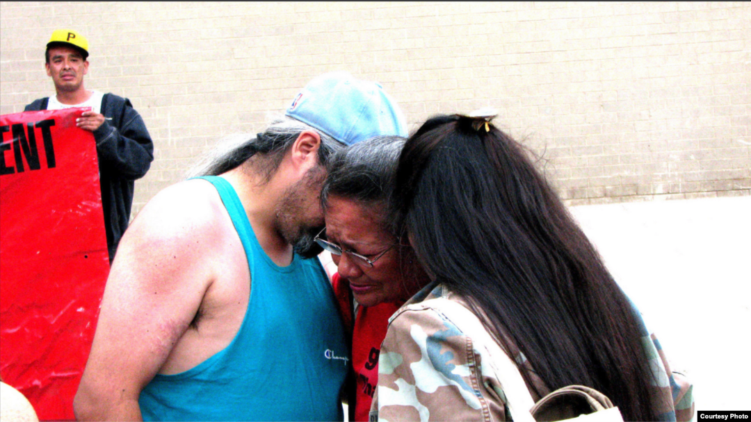 Lynn Eagle Feather, mother of police shooting victim Paul Castaway, is consoled by friends at rally in Denver, Co., July 12, 2015. (Courtesy/Steve Stalzle) 