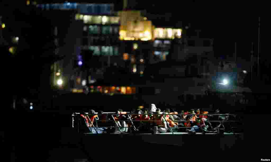 Migrants who were rescued by the Italian coastguard, arrive on an Armed Forces of Malta patrol boat in Valletta's Marsamxett Harbour, Malta, Sept. 17, 2019.