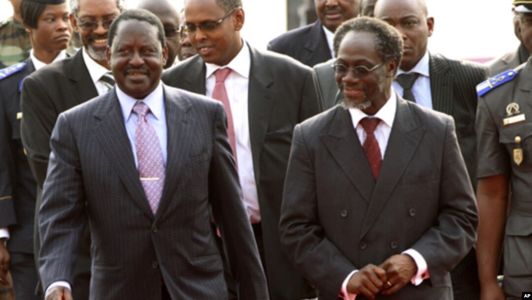 Kenya's PM Raila Odinga (l) walks with Gilbert Ake, named Prime Minister in the cabinet of Ivory Coast's incumbent leader Laurent Gbagbo, after arriving at the Felix Houphouet Boigny international airport in Abidjan, 03 Jan 2011.