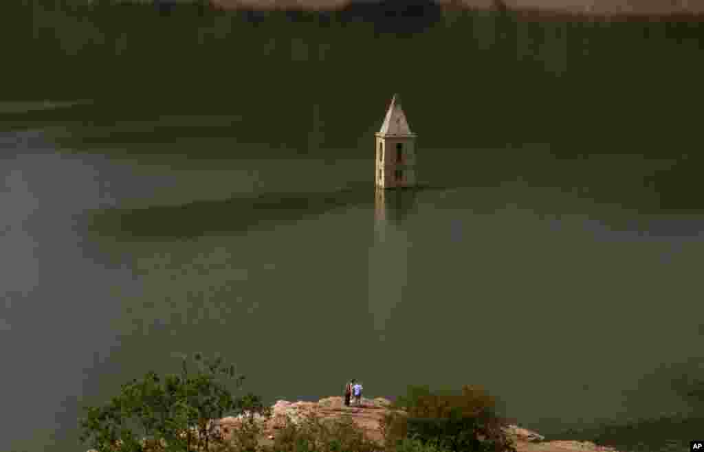 An 11th century Romanesque church, which is usually covered by water, is partially exposed in a reservoir in Vilanova de Sau, Catalonia, Spain.