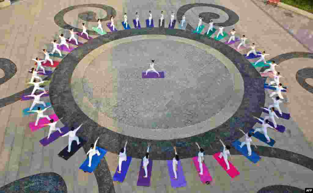 This aerial photo shows people practicing yoga at a park in Handan in China's northern Hebei province, China, ahead of International Yoga Day on June 21.