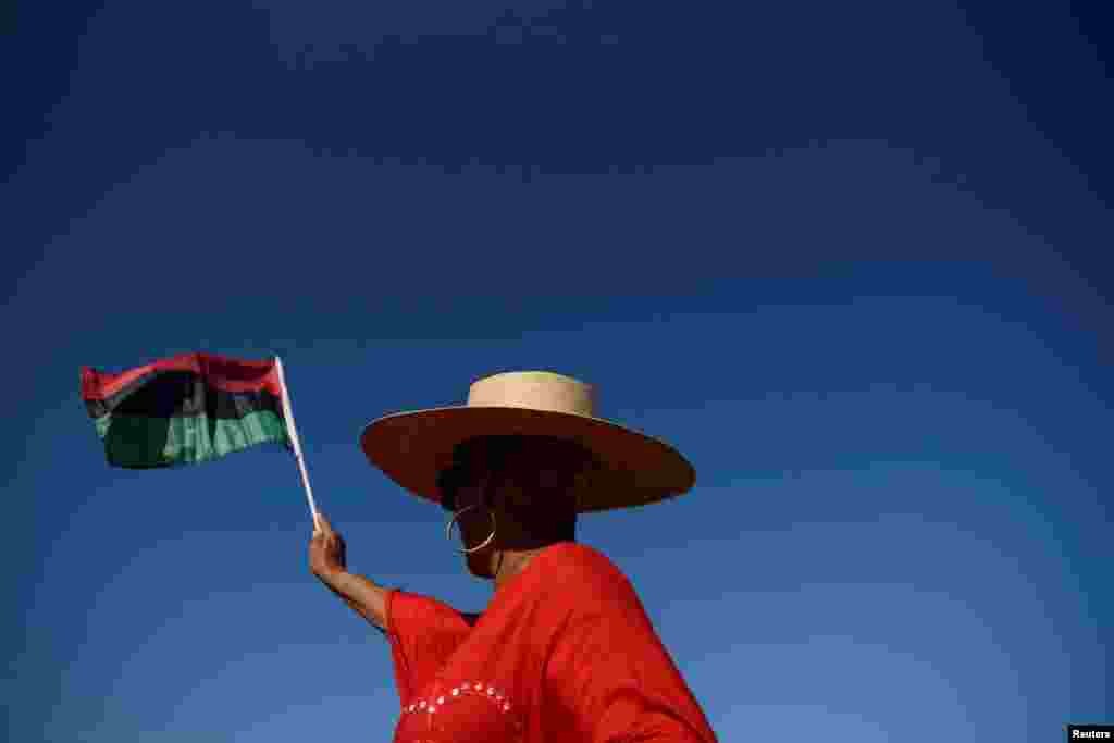 A person waves a flag during an emancipation march in Galveston, Texas, as people gather to celebrate Juneteenth, which commemorates the end of slavery in Texas, two years after the 1863 Emancipation Proclamation freed slaves elsewhere in the United States.