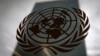 FILE - The United Nations headquarters building is pictured though a window with the U.N. logo in the foreground in New York, Aug. 15, 2014. 