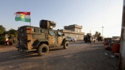 Iraqi forces and Kurdish Peshmerga fighters take part in an intensive security deployment after Islamic State militants took it over the previous day in Luhaiban village in Kirkuk, Iraq, Dec. 6,2021.