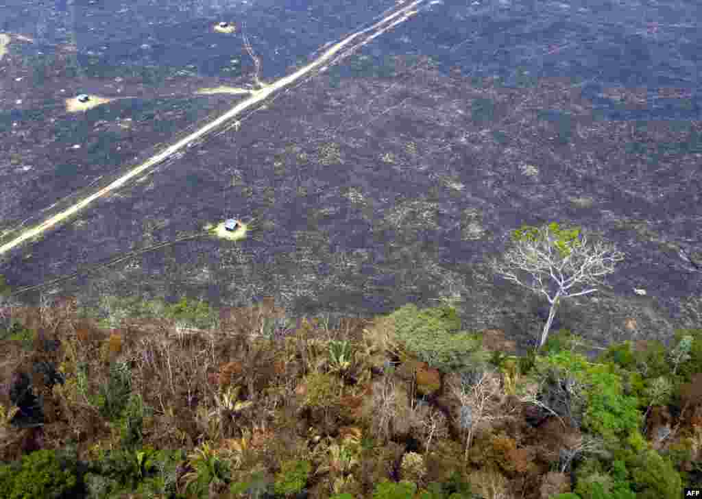 Aerial view of burnt areas of the Amazon rainforest, near Porto Velho, Rondonia state, Brazil, Aug. 24, 2019. President Jair Bolsonaro authorized the deployment of Brazil's armed forces to help combat fires raging in the Amazon rainforest, as a growing global outcry over the blazes sparks protests and threatens a huge trade deal.