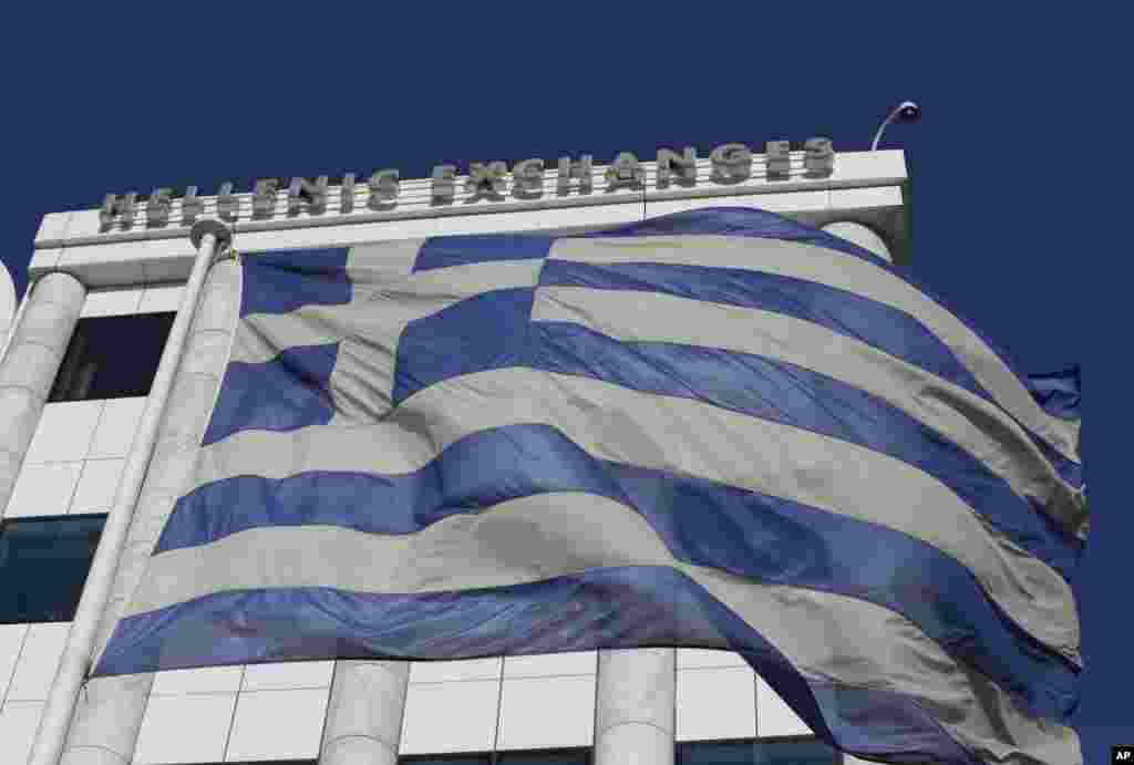 Greece was forced to call early national elections on Monday, stoking financial concerns as investors worry the main opposition party will win and renege on the country's bailout deal. In this photo, the Greek flag waves outside the stock exchange in Athens, Greece, Dec. 29, 2014. 