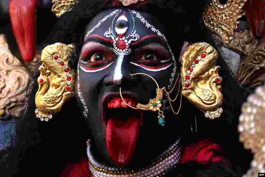 A devotee dressed as the Hindu deity Maha Kali performs during Navratri festival celebrations in Ajmer in Rajasthan state, India.