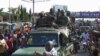 Residents cheer at army soldiers as they celebrate the uprising in Conakry, Guinea, Sept. 5, 2021. 