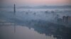 Dawn breaks over Pyongyang, North Korea, as buildings poke through the midst and the Juche Tower, left, stands by the Taedong riverbank, Oct. 13, 2015.