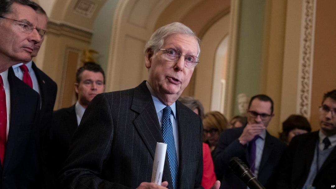 Senate Majority Leader Mitch McConnell, R-Ky., joined at left by Sen. John Barrasso, R-Wyo., and Sen. Todd Young, R-Ind., speaks to reporters asking about the threat of another government shutdown following a strategy meeting in Washington, Jan. 29, 2019