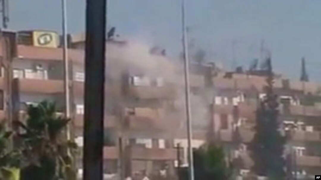 Smoke rises from a building in the Al Hader area of Hama.