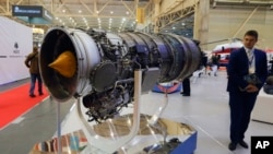A visitor looks at a turbofan AI-322F engine for combat trainers and light combat aircraft made by Ukraine's Motor Sich manufacturer at an international weapons exhibition in Kyiv on October 9, 2018.
