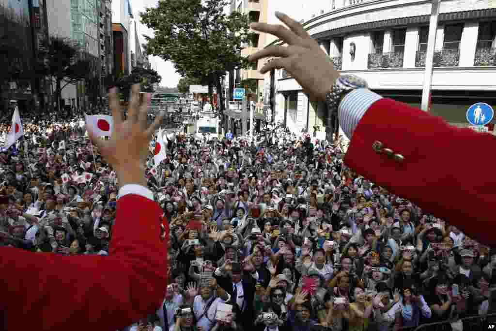 Japanese medalists of the Rio de Janeiro Summer Olympics wave from a bus to cheering people during a parade in Tokyo's Ginza district. Tokyo will host the 2020 Olympics and Paralympics.