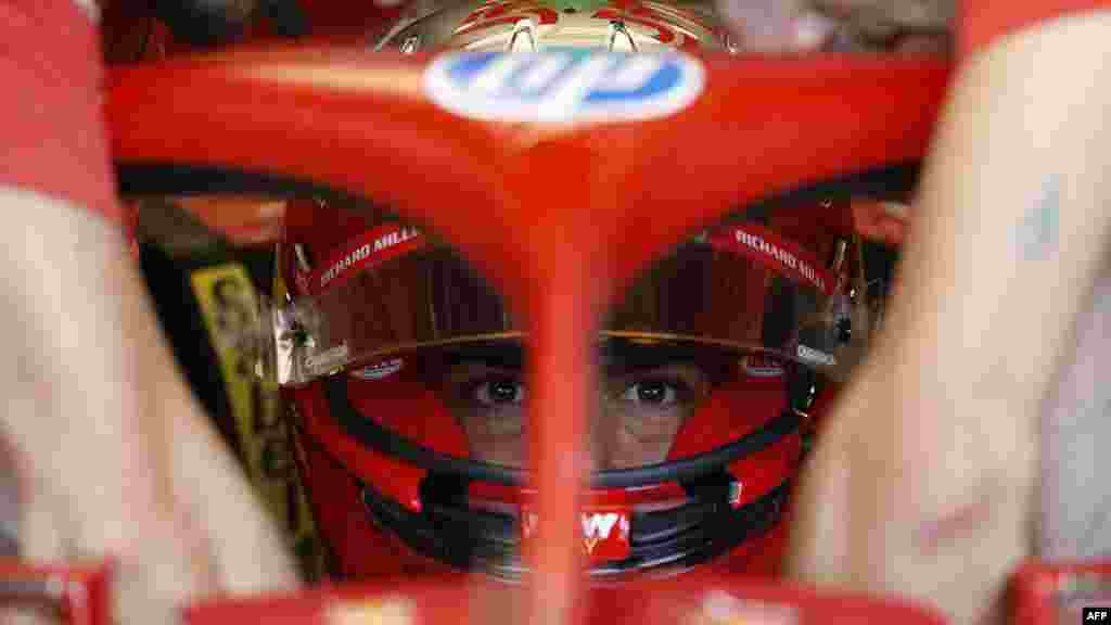 Ferrari's Spanish driver Carlos Sainz sits inside his car during the practice session for the Formula One Sao Paulo Grand Prix in Sao Paulo.