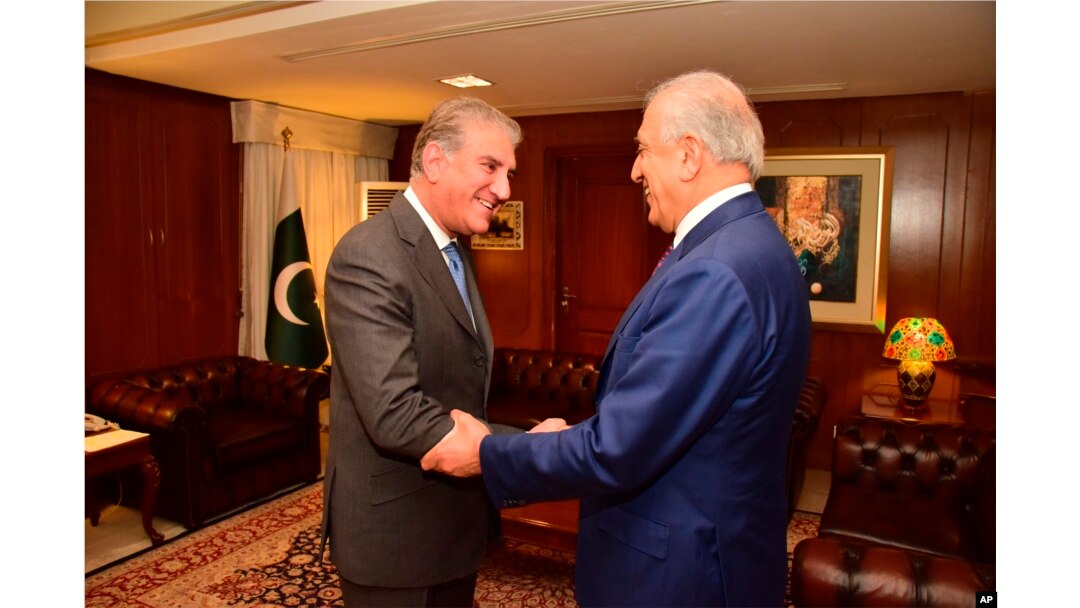 In this photo released by the Foreign Office, Pakistan's Foreign Minister Shah Mahmood Qureshi, left, receives U.S. envoy Zalmay Khalilzad at the Foreign Ministry in Islamabad, Pakistan, Jan. 18, 2019.
