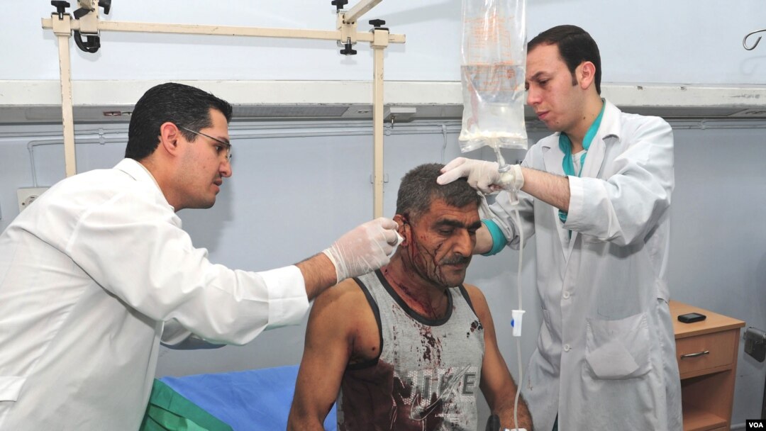 Syrian doctors treat an injured man who was wounded after two bombs exploded, at Qazaz neighborhood in Damascus, Syria, May 10, 2012.