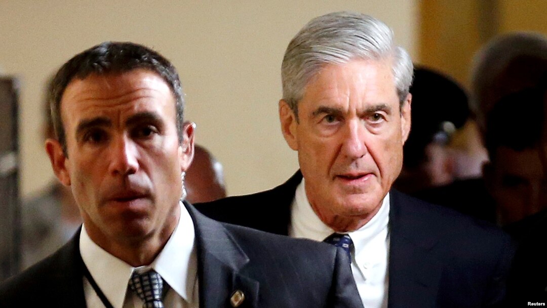 FILE : Special Counsel Robert Mueller, right, departs after briefing members of the U.S. Senate on his investigation into potential collusion between Russia and the Trump campaign on Capitol Hill in Washington, June 21, 2017. 