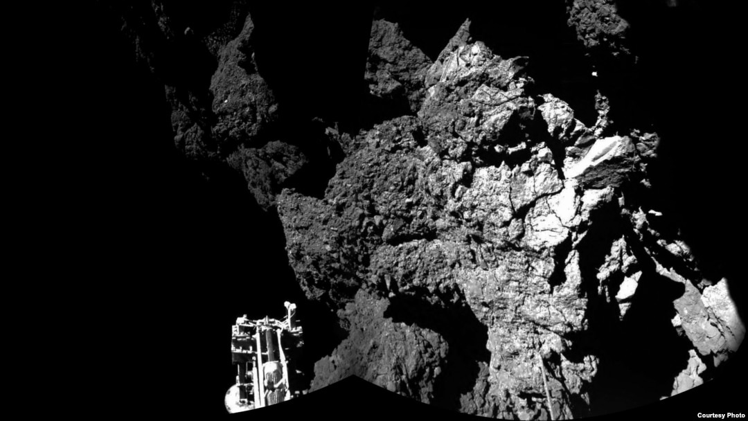FILE - Rosetta’s lander Philae is safely on the surface of Comet 67P/Churyumov-Gerasimenko, as these first two CIVA images confirm. One of the lander’s three feet can be seen in the foreground. The image is a two-image mosaic, Nov. 13, 2014. (Courtesy: ESA) 