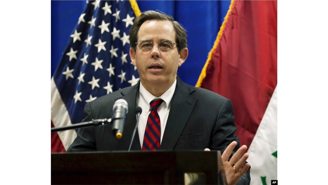 FILE - In this Oct. 1, 2015, photo, Stuart Jones speaks at a news conference at the U.S. Embassy in Baghdad, Iraq. The Trump administration is accusing the Syrian government of carrying out mass killings of thousands of prisoners and burning the dead bodi