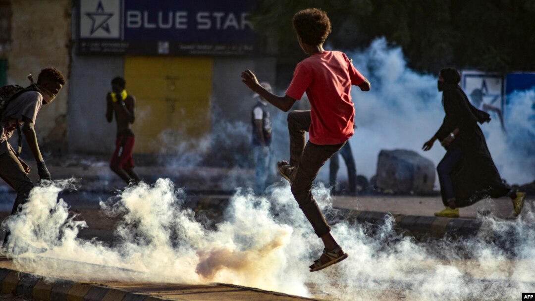 Sudanese youths take to the streets as security forces use tear gas to disperse protesters in the capital Khartoum, on October 27, 2021.