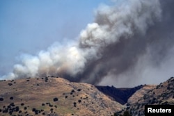 Smoke rises amid ongoing cross-border hostilities between Hezbollah and Israeli forces, in the Israeli-occupied Golan Heights, on June 13, 2024.