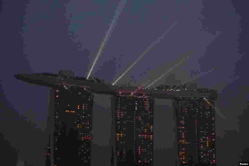 A laser light show plays from the top of the Marina Bay Sands integrated resort during haze in Singapore.