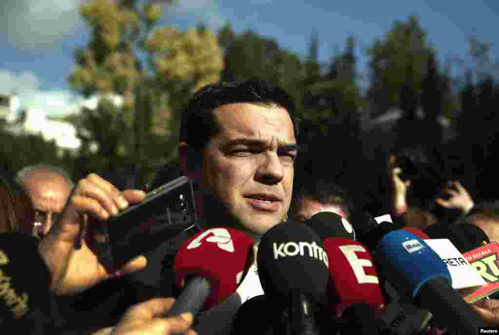 Alexis Tsipras, opposition leader and head of radical leftist Syriza party, talks to reporters outside the parliament building after the last round of presidential voting, Athens, Dec. 29, 2014. 