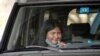 FILE - Ashley Ruiz gives herself a COVID-19 nasal swab test while sitting in a car at a drive-up CVS pharmacy in Dallas, Sept. 18, 2020.