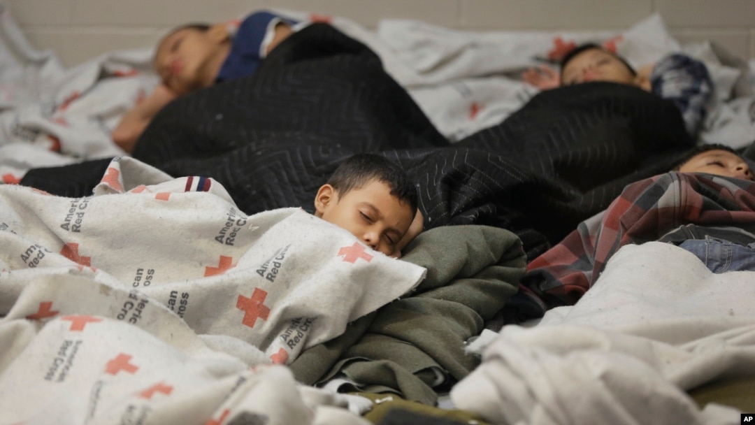 FILE - This June 18, 2014, file photo shows children detainees sleeping in a holding cell at a U.S. Customs and Border Protection processing facility in Brownsville,Texas. 