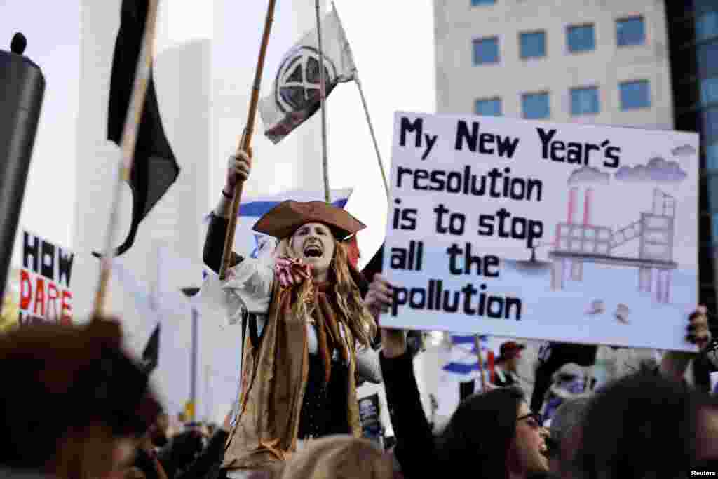 A protester holds a placard during a demonstration against Israel's offshore Leviathan natural gas field due to environmental concerns in Tel Aviv, Israel.